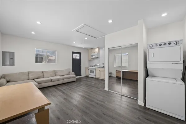 a large white kitchen with a stove a sink and a refrigerator