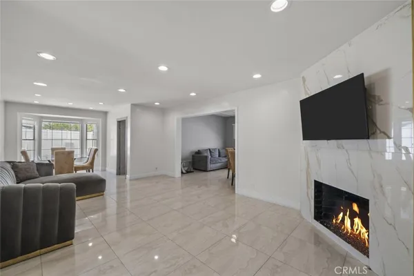 a living room with furniture a fireplace and a flat screen tv