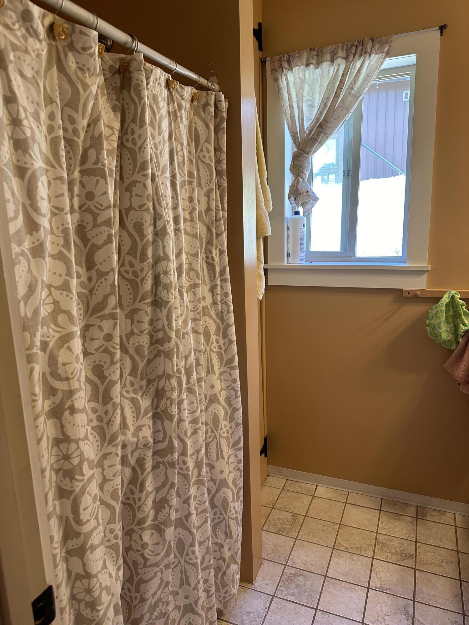 83000 Milstead Road Garberville, CA 95542 - Photo 16 of 67 a view of a bathroom with a shower curtain