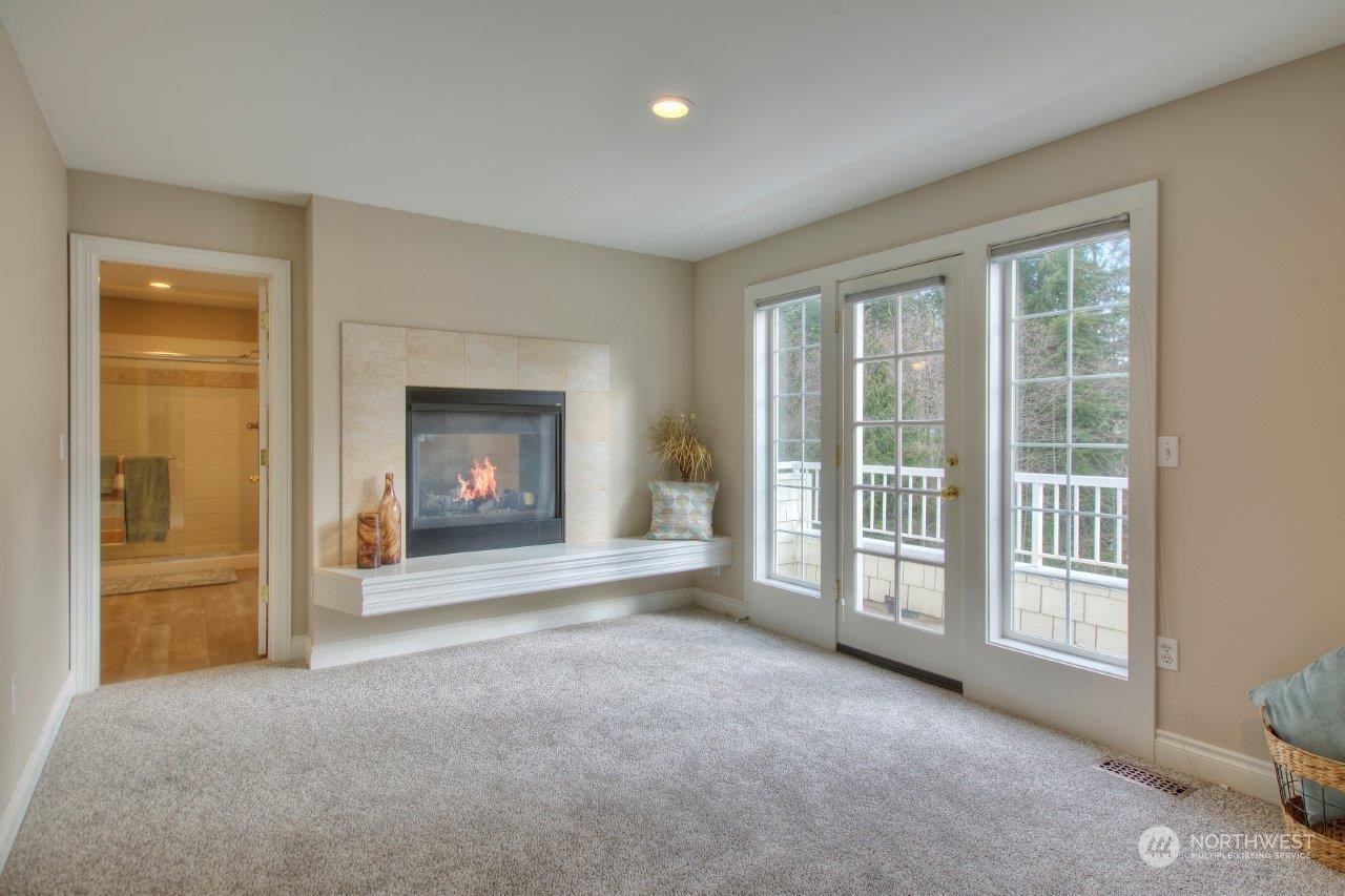 19929 183rd Way Southeast Renton, WA 98058 - Photo 24 of 38 a view of an empty room with a fireplace and a window