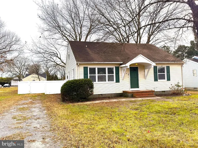 a front view of house with yard and trees