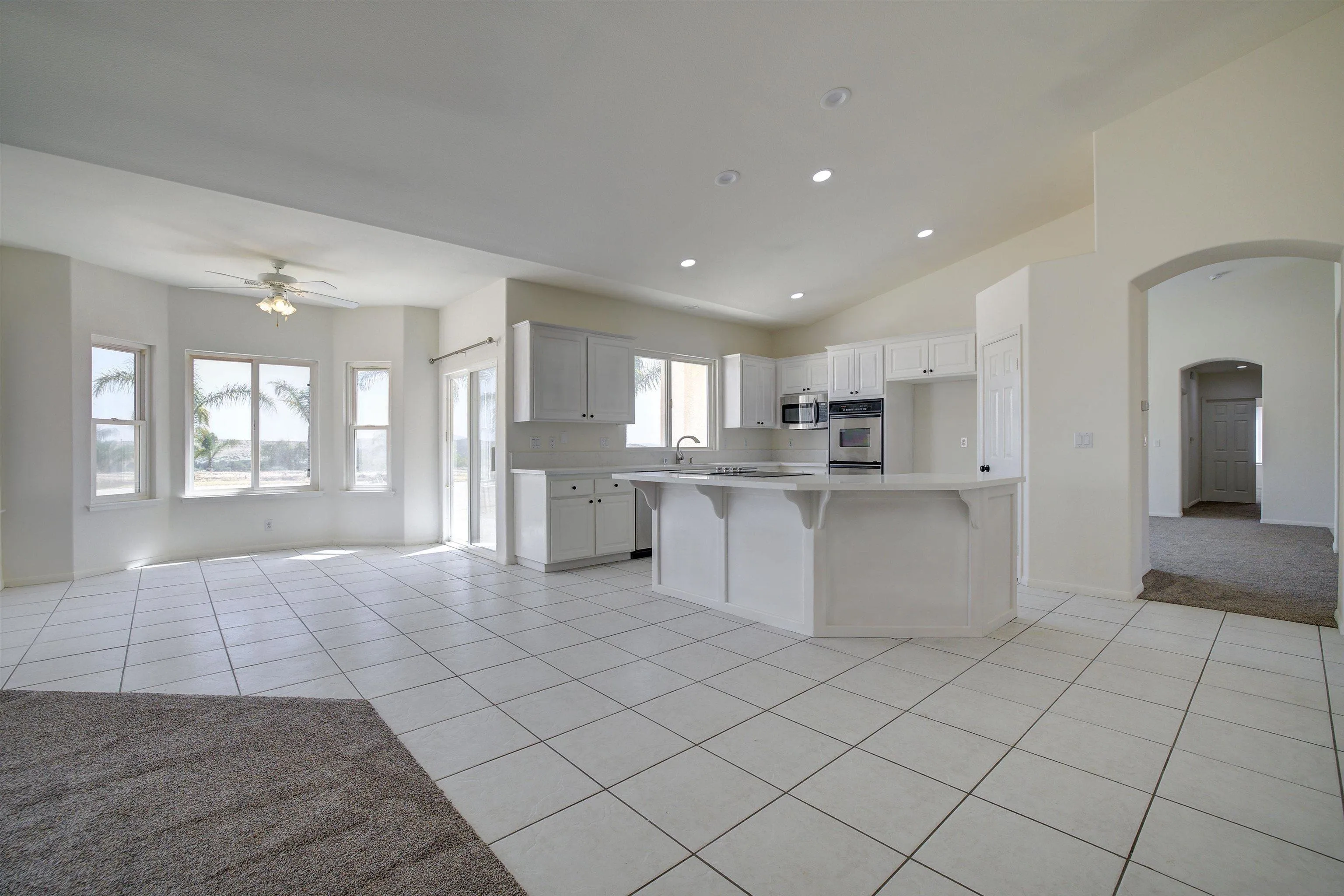31250 Rivoli Road Valley Center, CA 92082 - Photo 15 of 57 a large white kitchen with a large window