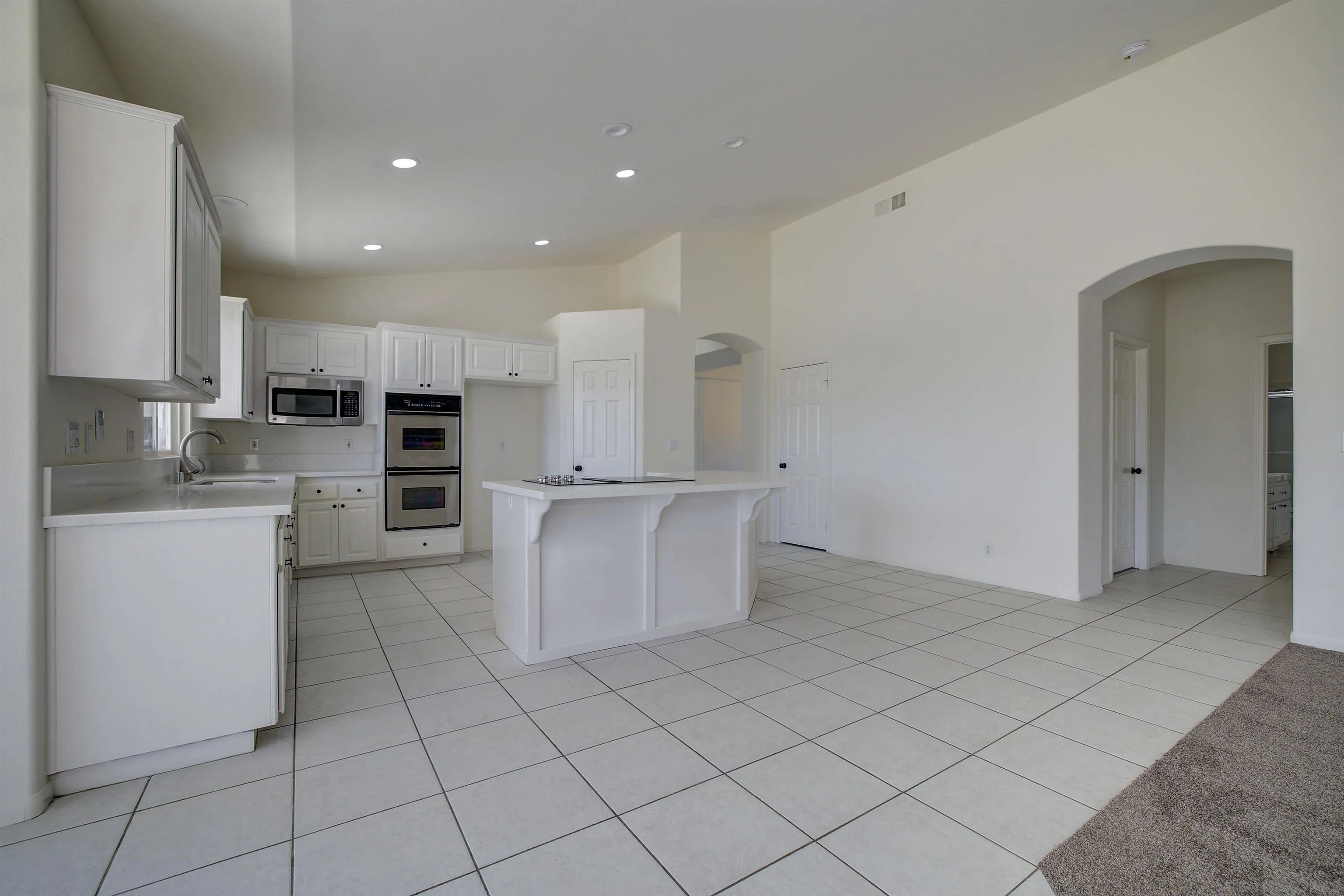 31250 Rivoli Road Valley Center, CA 92082 - Photo 16 of 57 a kitchen with cabinets and a refrigerator