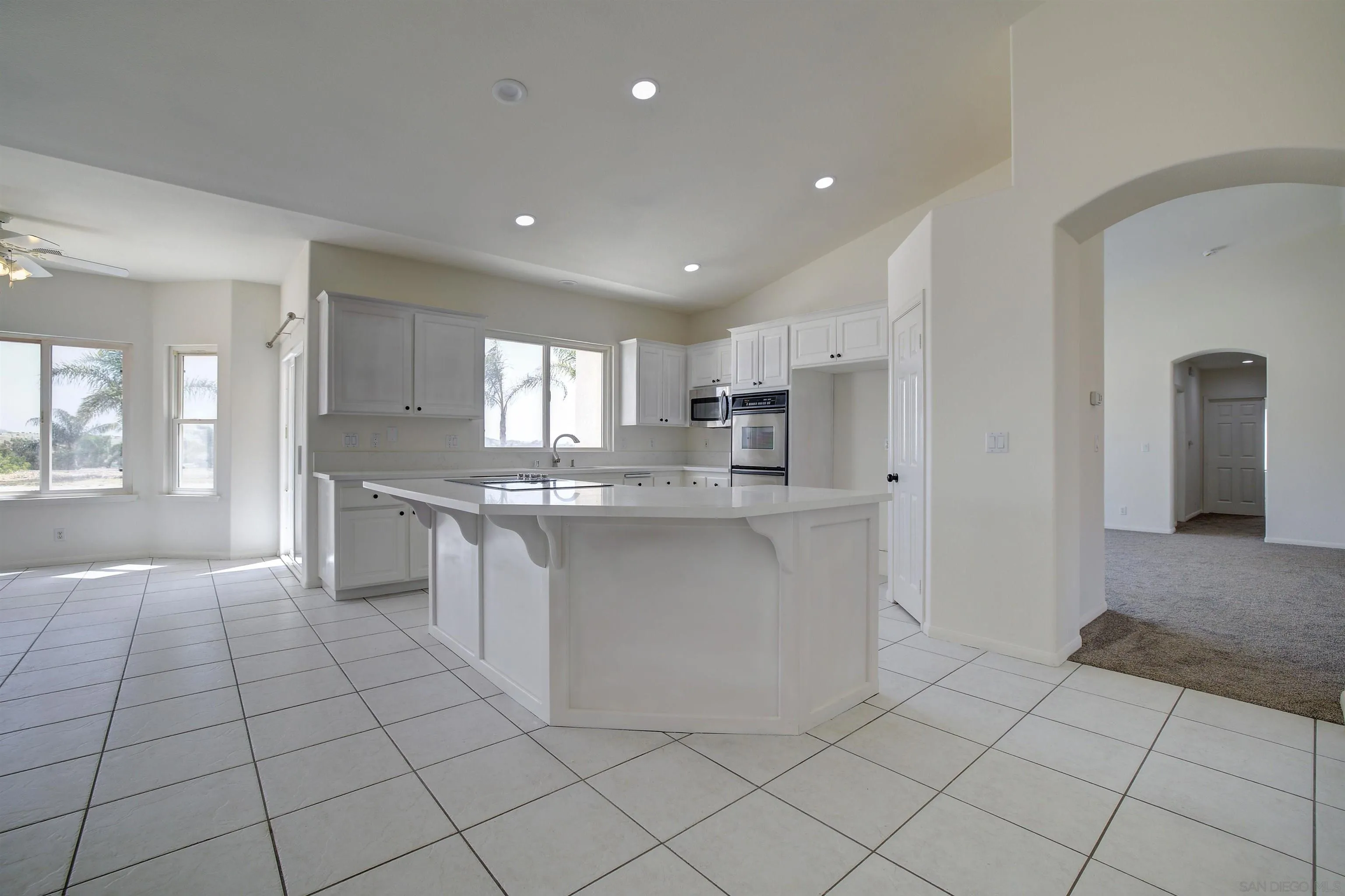31250 Rivoli Road Valley Center, CA 92082 - Photo 18 of 57 a large white kitchen with cabinets