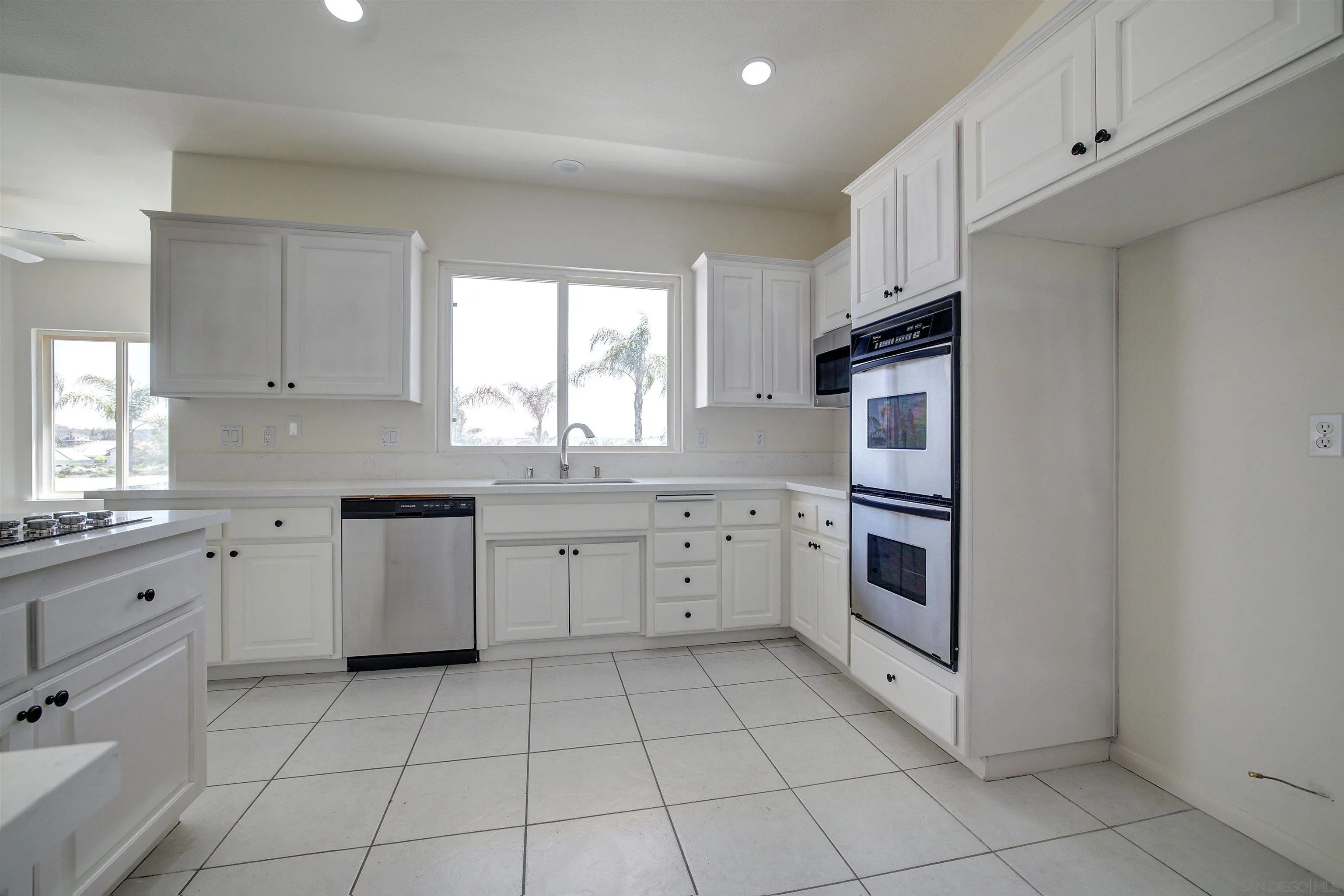 31250 Rivoli Road Valley Center, CA 92082 - Photo 19 of 57 a kitchen with cabinets appliances and a window
