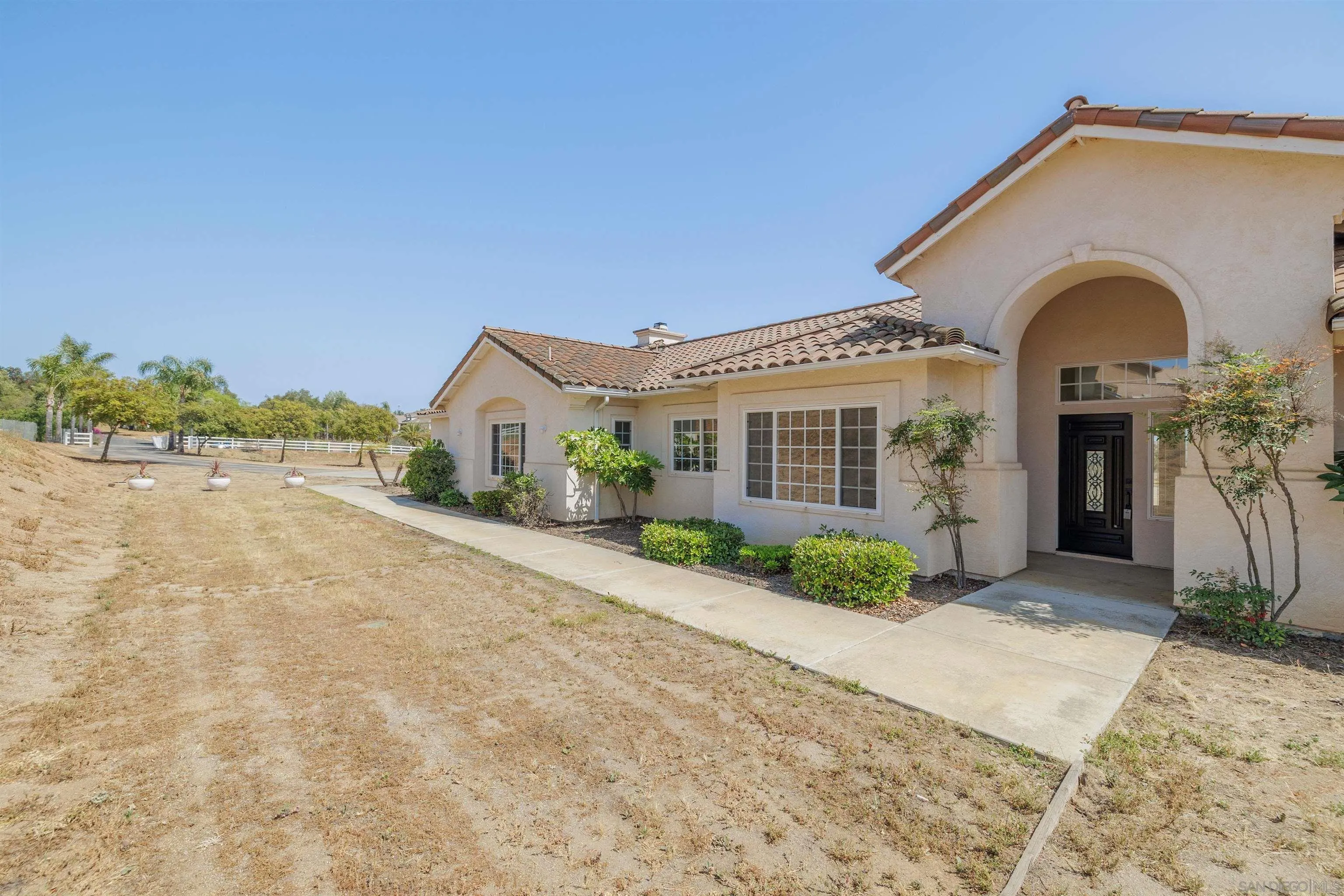 31250 Rivoli Road Valley Center, CA 92082 - Photo 2 of 57 a front view of a house with a yard and garage