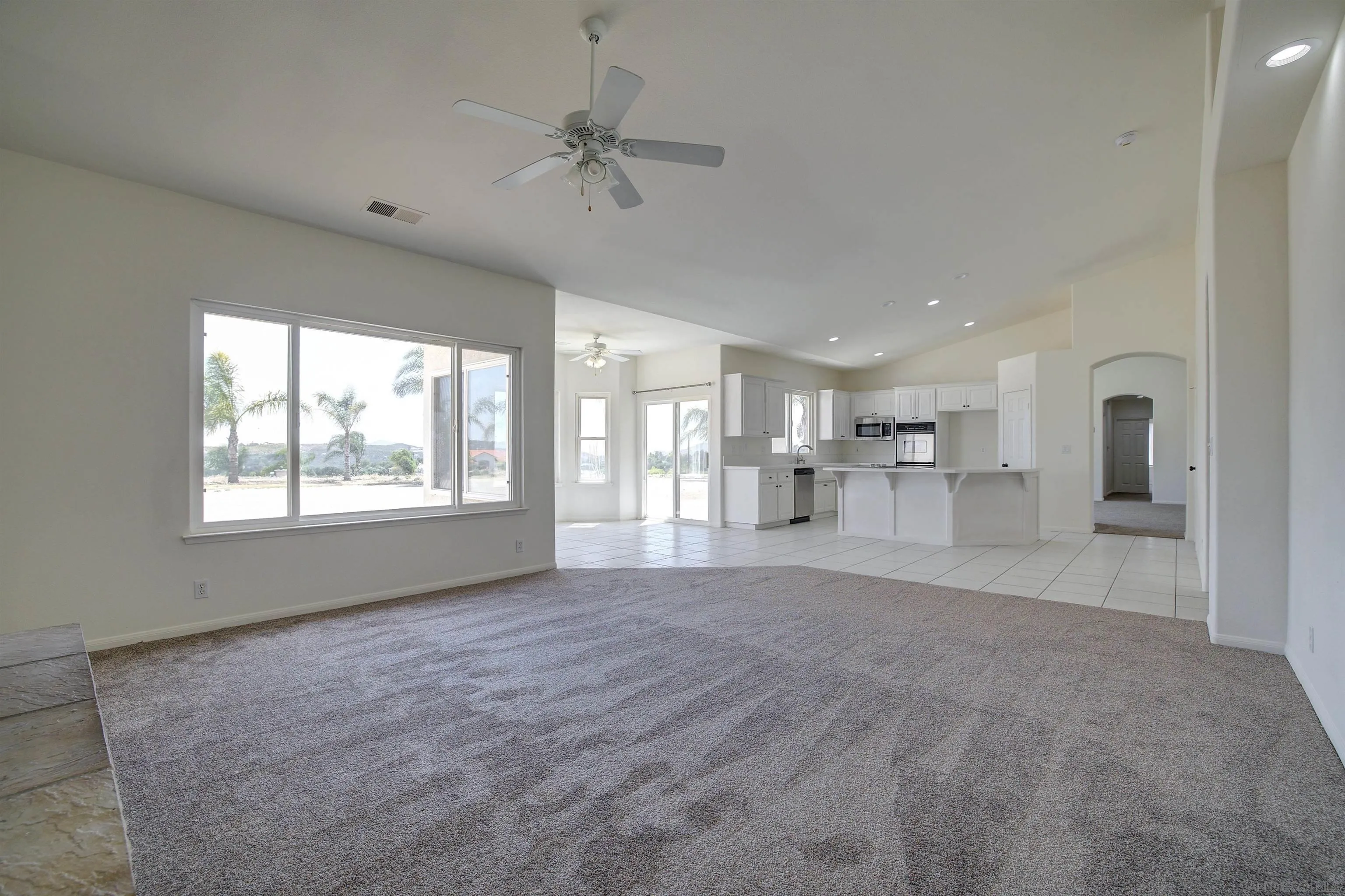 31250 Rivoli Road Valley Center, CA 92082 - Photo 23 of 57 a view of a livingroom with a kitchen stove a faucet cabinets and a window