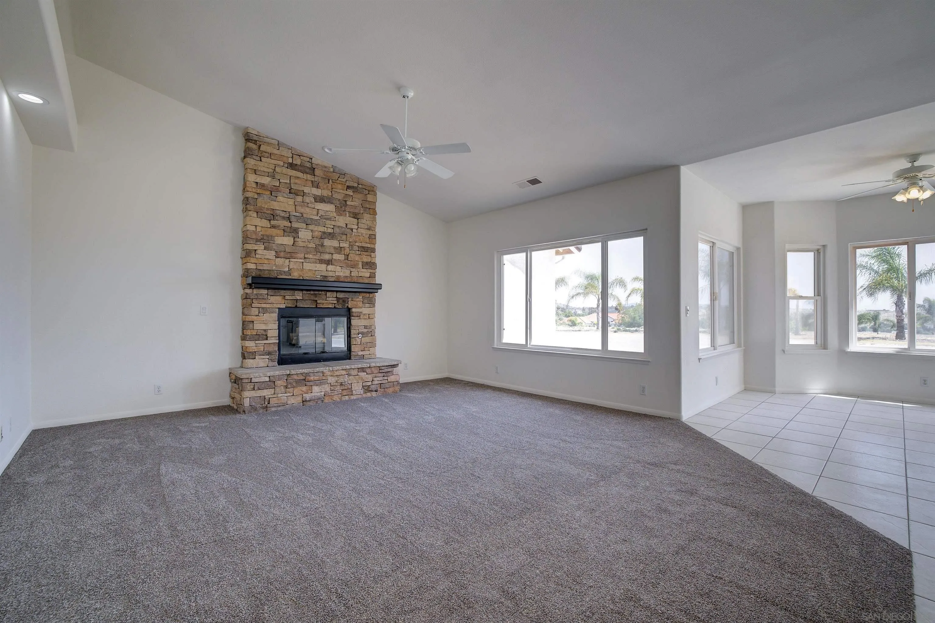 31250 Rivoli Road Valley Center, CA 92082 - Photo 25 of 57 an empty room with windows and fireplace