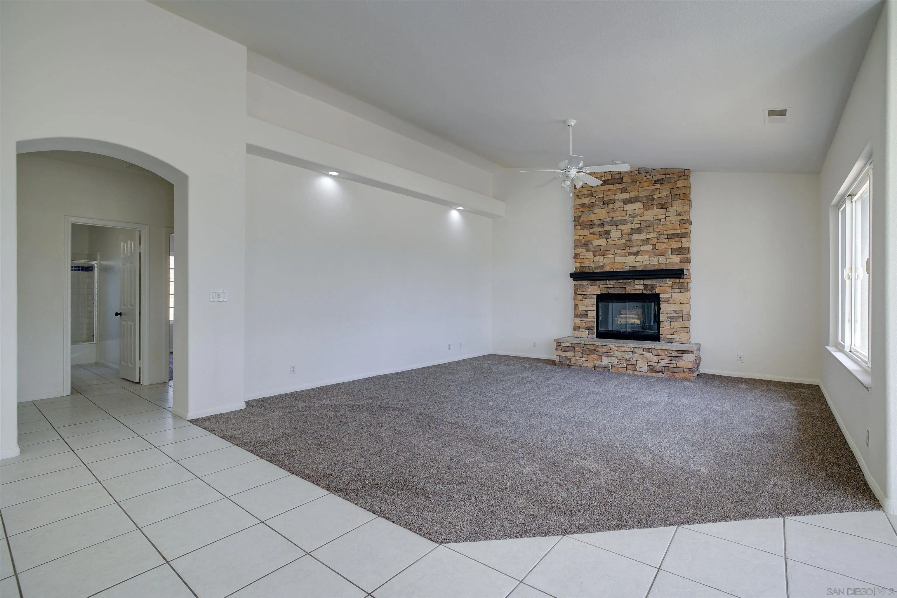 31250 Rivoli Road Valley Center, CA 92082 - Photo 26 of 57 an empty room with fireplace and windows