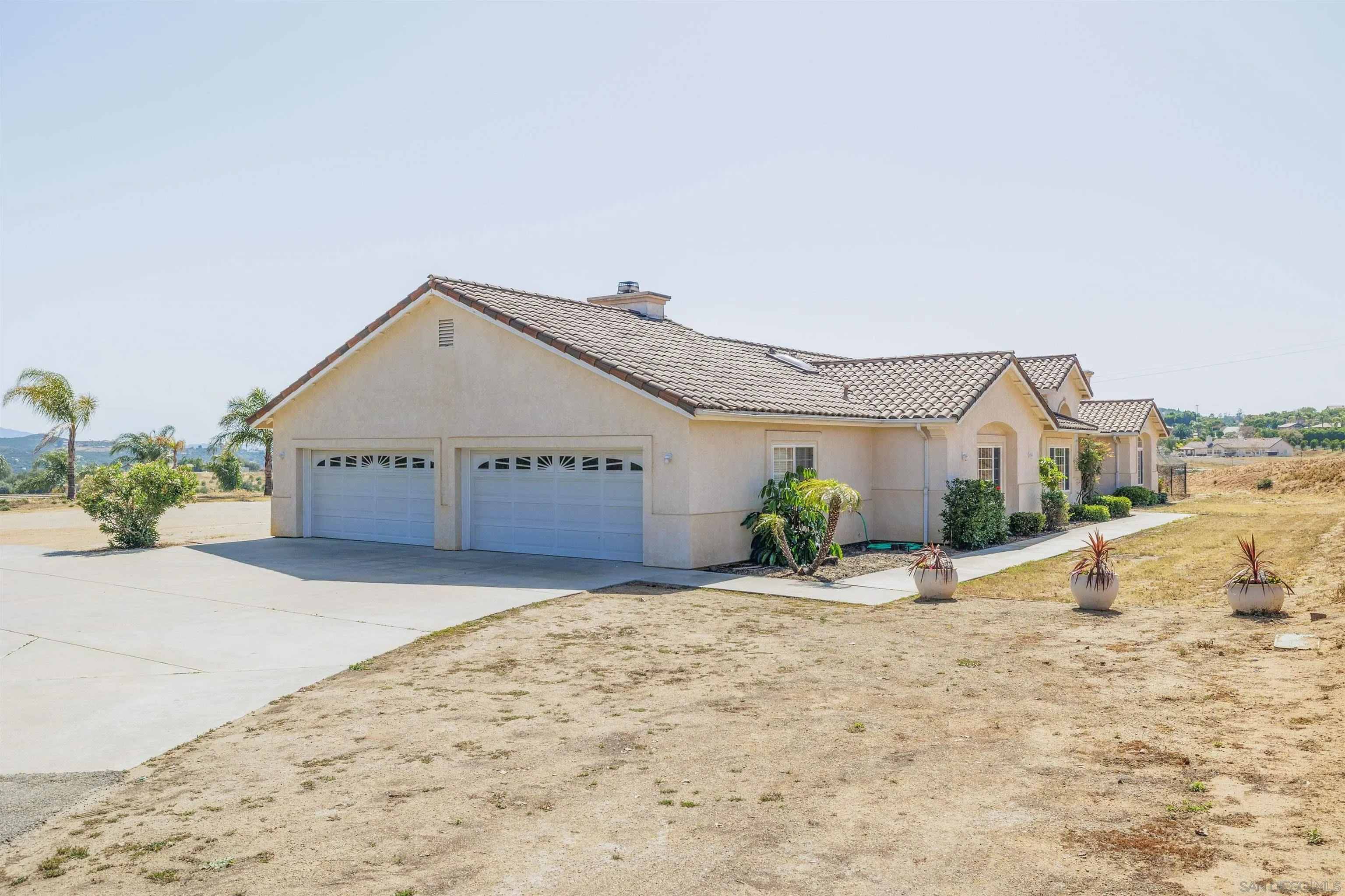 31250 Rivoli Road Valley Center, CA 92082 - Photo 4 of 57 a view of a house with a dry yard and a large window