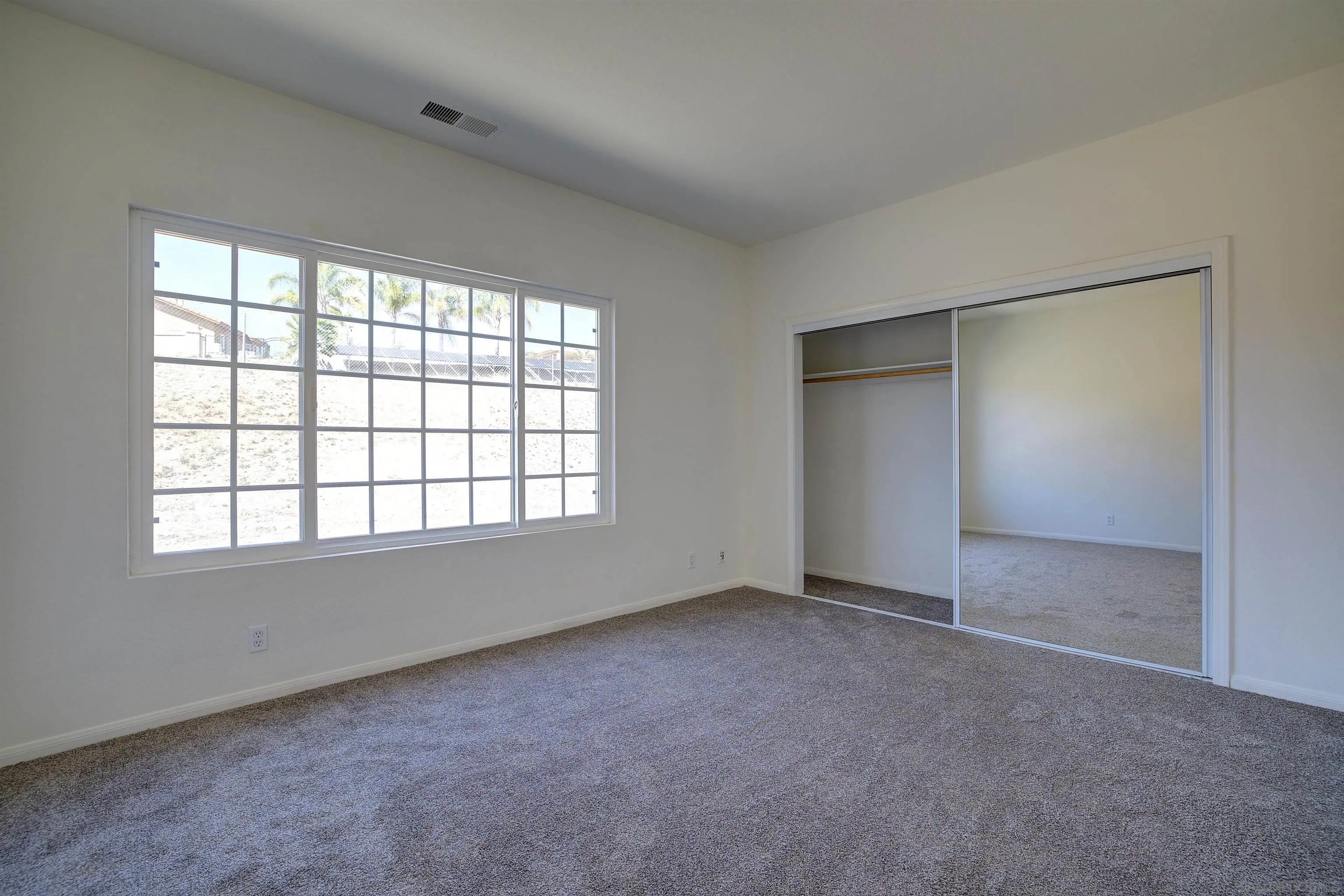 31250 Rivoli Road Valley Center, CA 92082 - Photo 42 of 57 an empty room with windows and closet