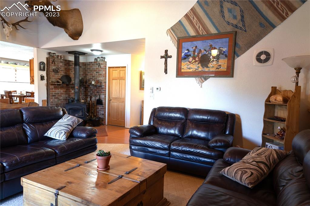 3370 Schieffelin Road Fort Garland, CO 81133 - Photo 12 of 46 a living room with furniture and a fireplace
