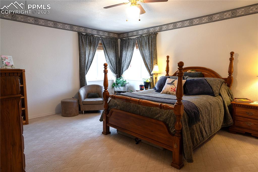 3370 Schieffelin Road Fort Garland, CO 81133 - Photo 20 of 46 a bedroom with a bed and a chandelier