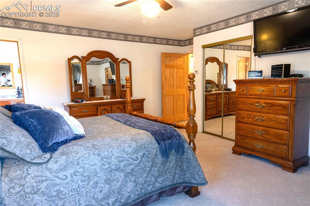 3370 Schieffelin Road Fort Garland, CO 81133 - Photo 22 of 46 a bedroom with a bed and a flat tv screen