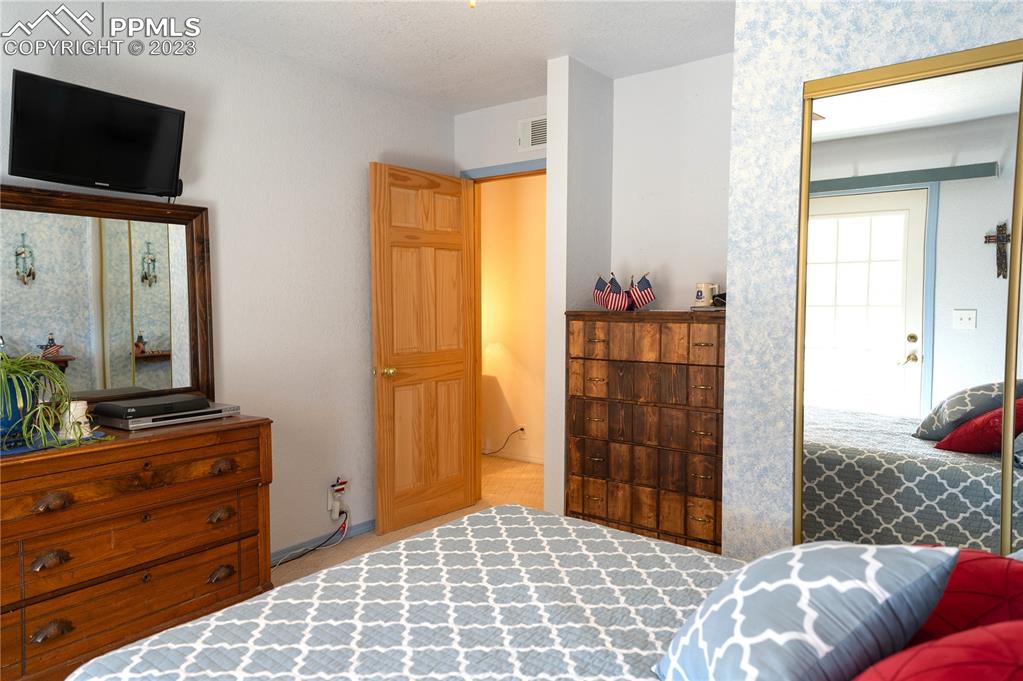 3370 Schieffelin Road Fort Garland, CO 81133 - Photo 31 of 46 a bedroom with a bed and flat screen tv