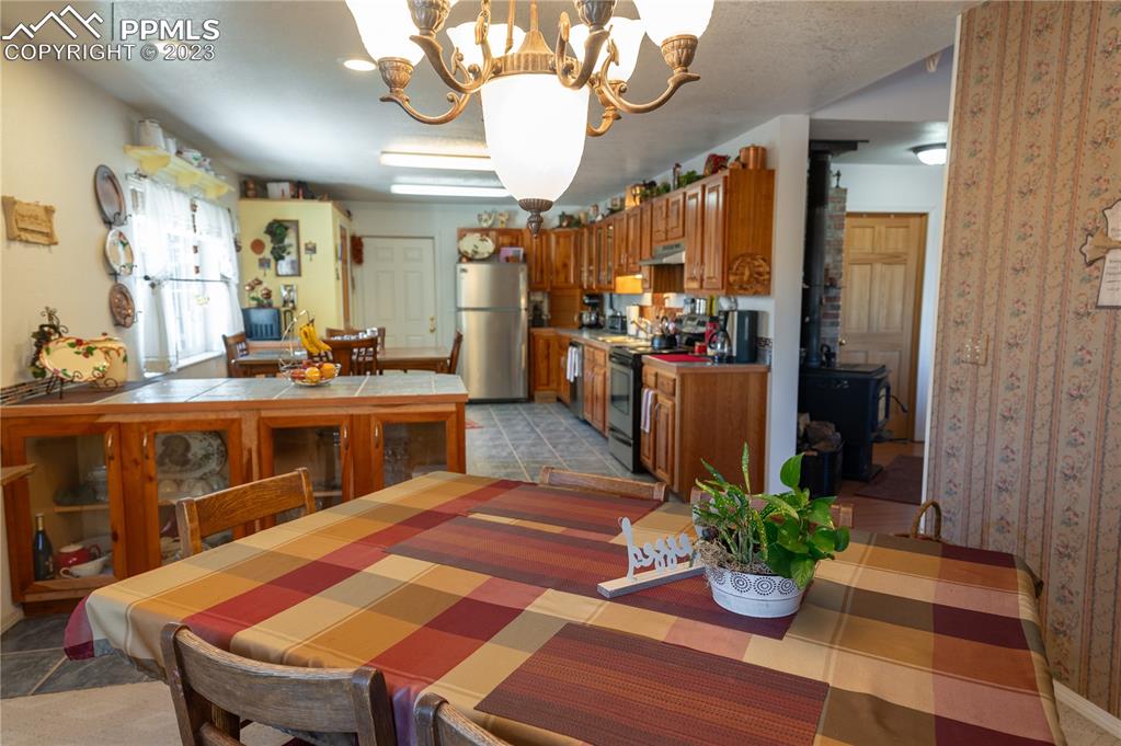 3370 Schieffelin Road Fort Garland, CO 81133 - Photo 9 of 46 a view of a dining room with furniture and a chandelier