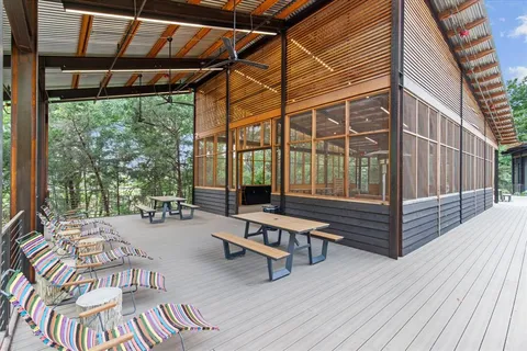a view of a patio with table and chairs and wooden floor