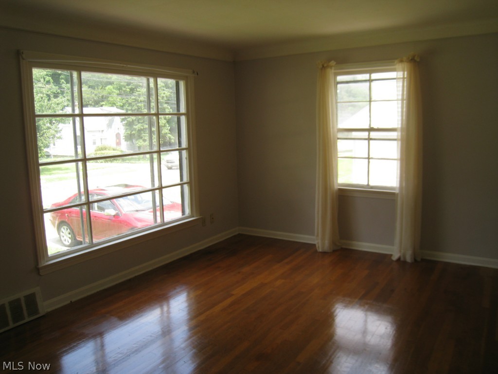 4674 Liberty Road South Euclid, OH 44121 - Photo 9 of 18 Just look at this gleaming hardwood floor in the living room. Large windows flood the room with natural light.