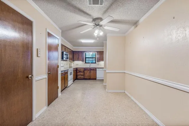 a view of a kitchen with a sink and cabinet area