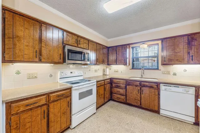 a kitchen with sink cabinets and microwave