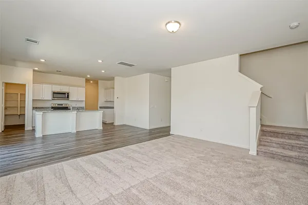 a view of kitchen with refrigerator and microwave