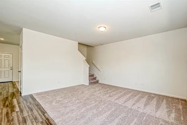 an empty room with wooden floor