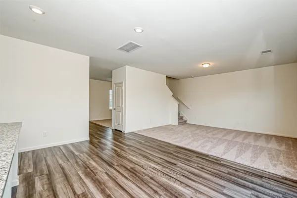 a view of an empty room and wooden floor