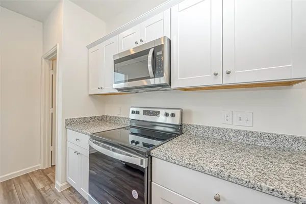 a kitchen with a sink stove and cabinets