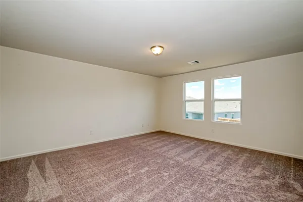 an empty room with windows and closet