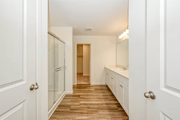 a bathroom with a glass shower door