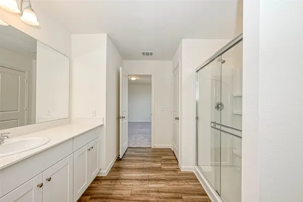 a bathroom with a sink double vanity and a mirror