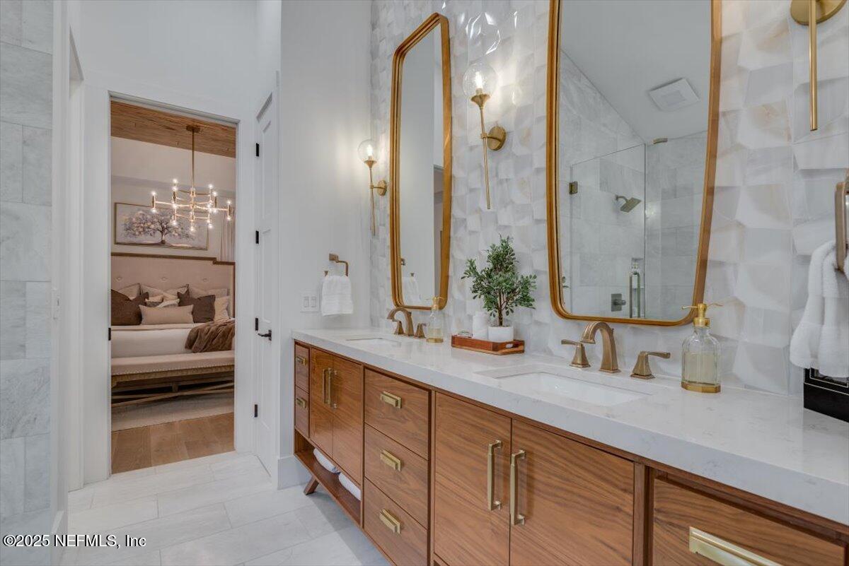 4009 Sioux Circle St. Johns, FL 32259 - Photo 32 of 49 a bathroom with a double vanity sink mirror and shower