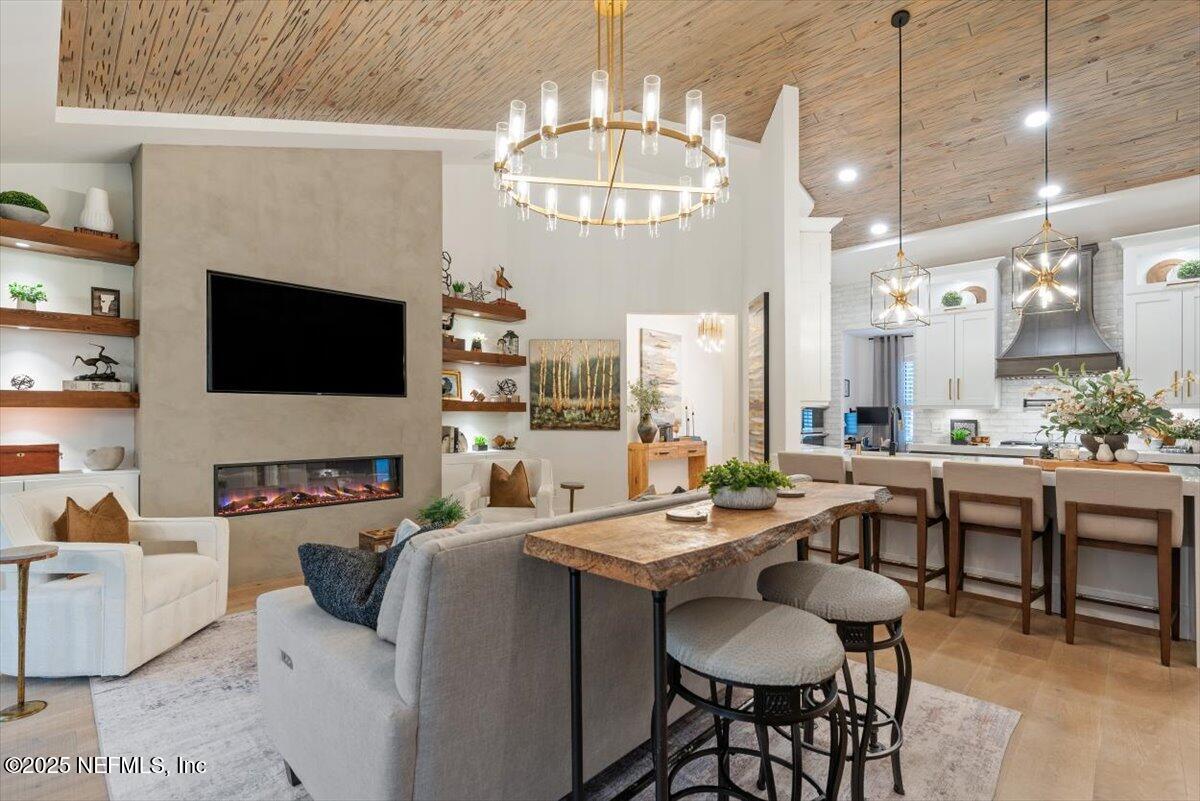 4009 Sioux Circle St. Johns, FL 32259 - Photo 10 of 49 a very nice looking dining room with furniture a fireplace and a chandelier