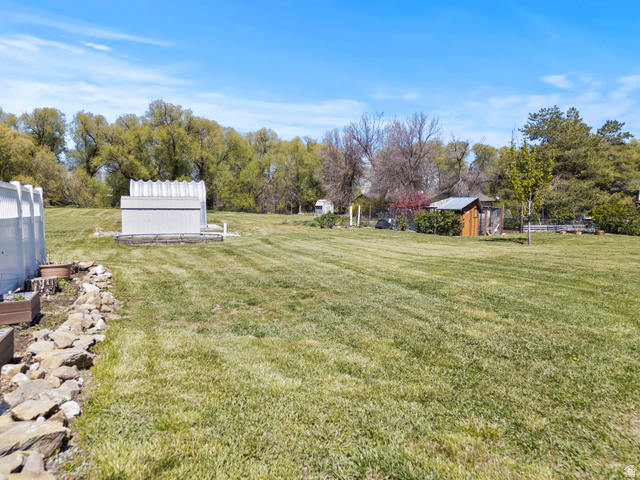75 East 200 North Mendon, UT 84325 - Photo 23 of 36 View of grassy yard with a storage shed