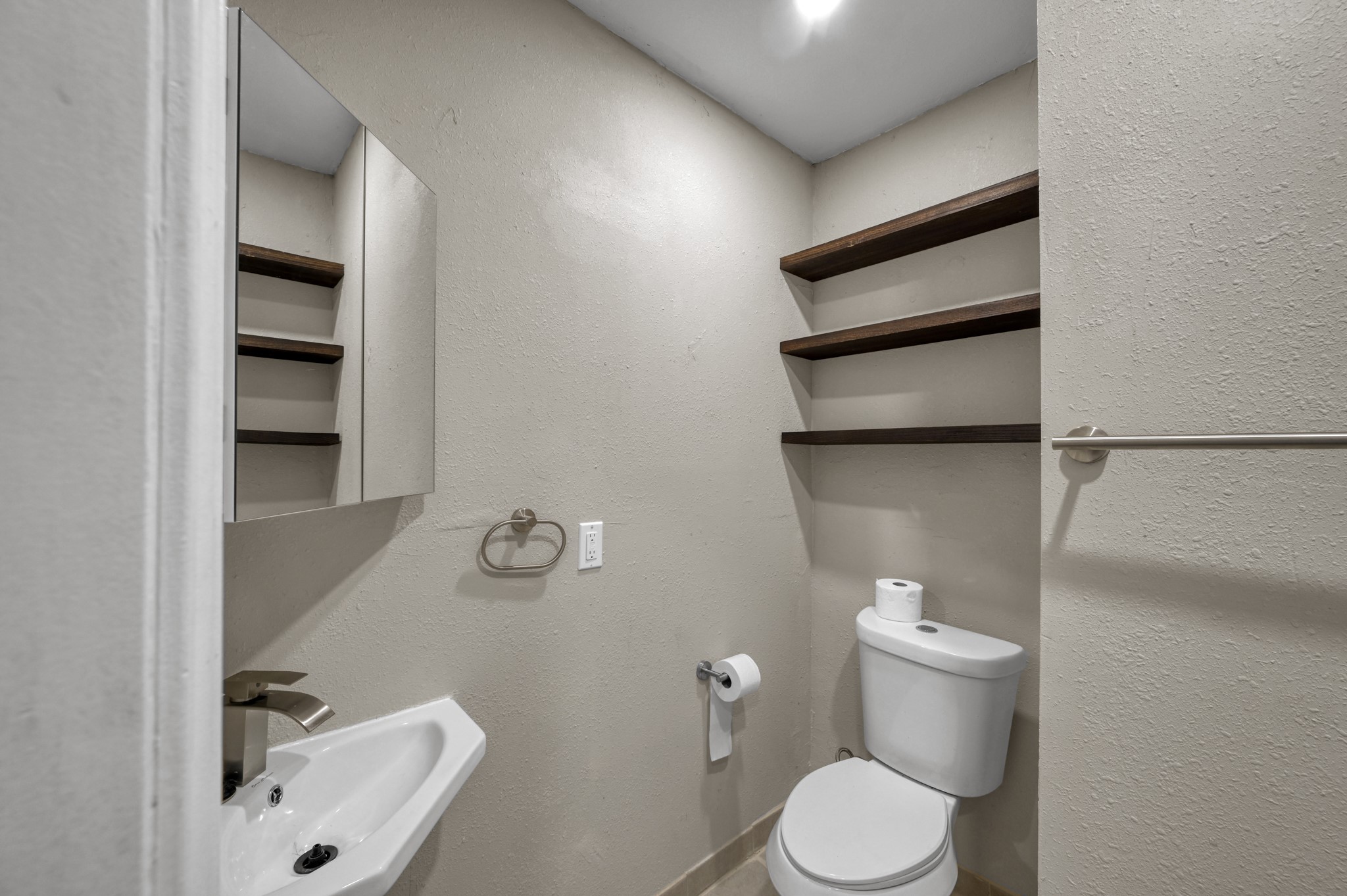 13544 Northshore Loop Conroe, TX 77304 - Photo 26 of 34 Second bathroom is open to guests and features a new pedestal sink along with new tile flooring for a fresh, updated look.