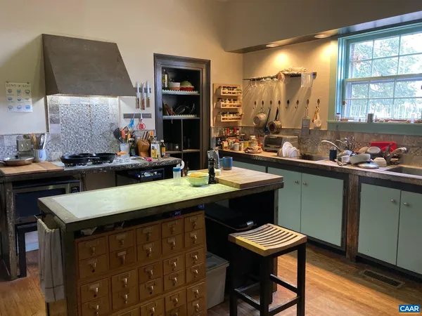 a kitchen with a sink cabinets and wooden floor