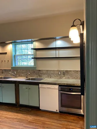 a kitchen with granite countertop a stove and a sink