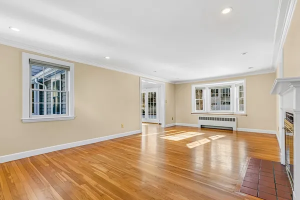 a view of a livingroom with wooden floor and a window