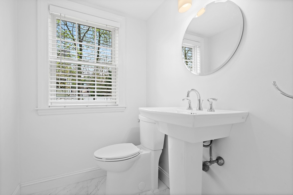 2270 Massachusetts Avenue Lexington, MA 02421 - Photo 15 of 33 a bathroom with a toilet a sink a mirror and a window