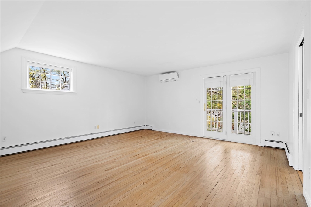 2270 Massachusetts Avenue Lexington, MA 02421 - Photo 18 of 33 a view of an empty room with wooden floor and a window