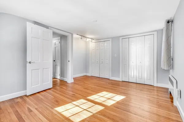 a view of a room with wooden floor and natural light