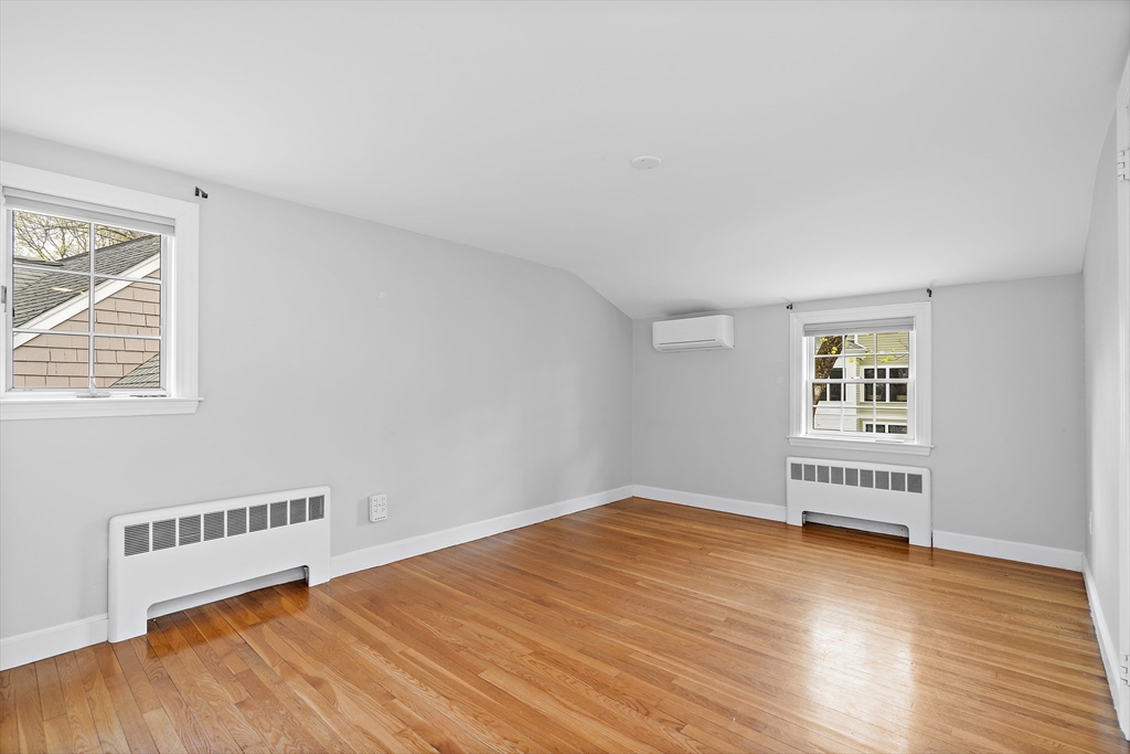 2270 Massachusetts Avenue Lexington, MA 02421 - Photo 26 of 33 a view of an empty room with wooden floor and a window
