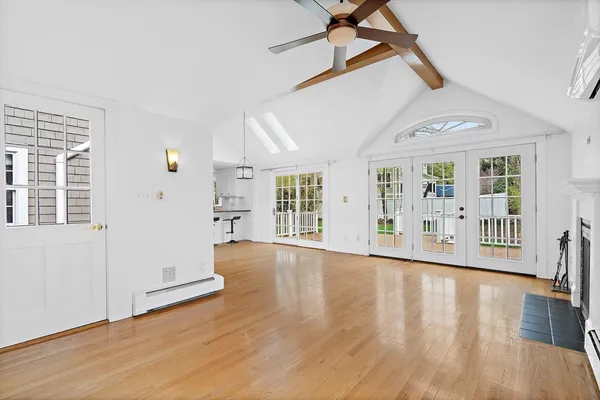 a view of a hallway with wooden floor and entryway