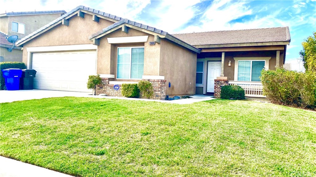 13606 Fox Point Road Victorville, CA 92392 - Photo 1 of 1 a front view of a house with a yard and porch
