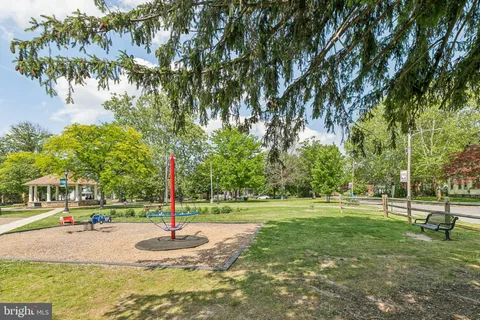 a garden with trees in the background