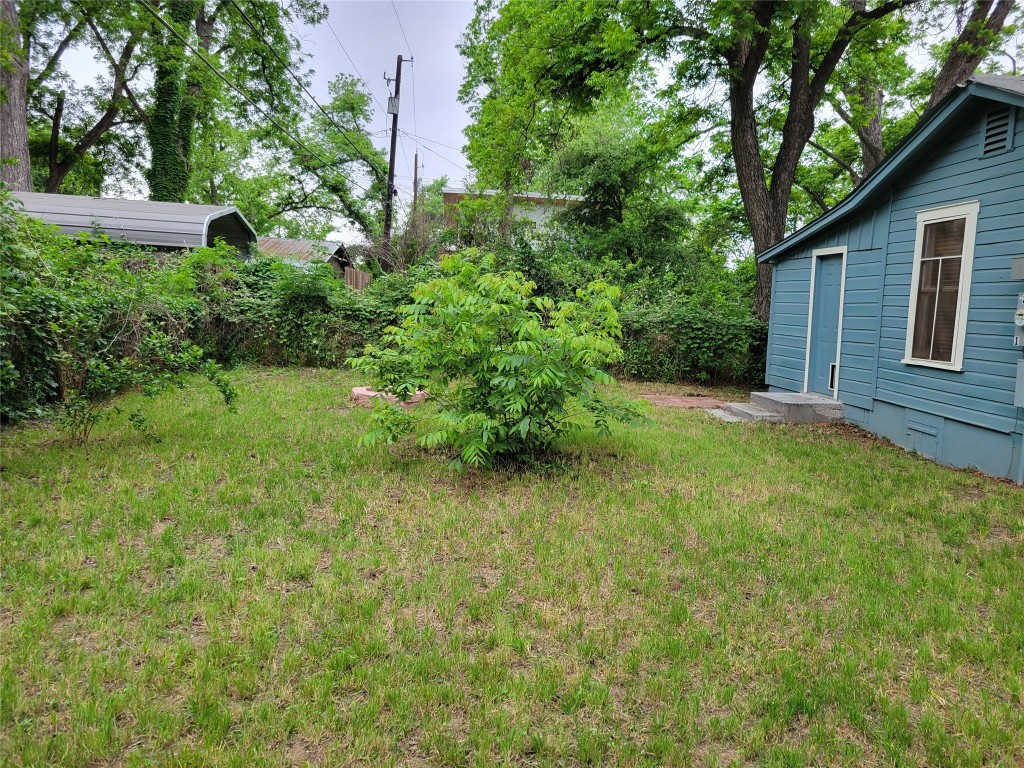 2511 East 2nd Street, Unit B Austin, TX 78702 - Photo 4 of 11 a view of a backyard with potted plants and large trees