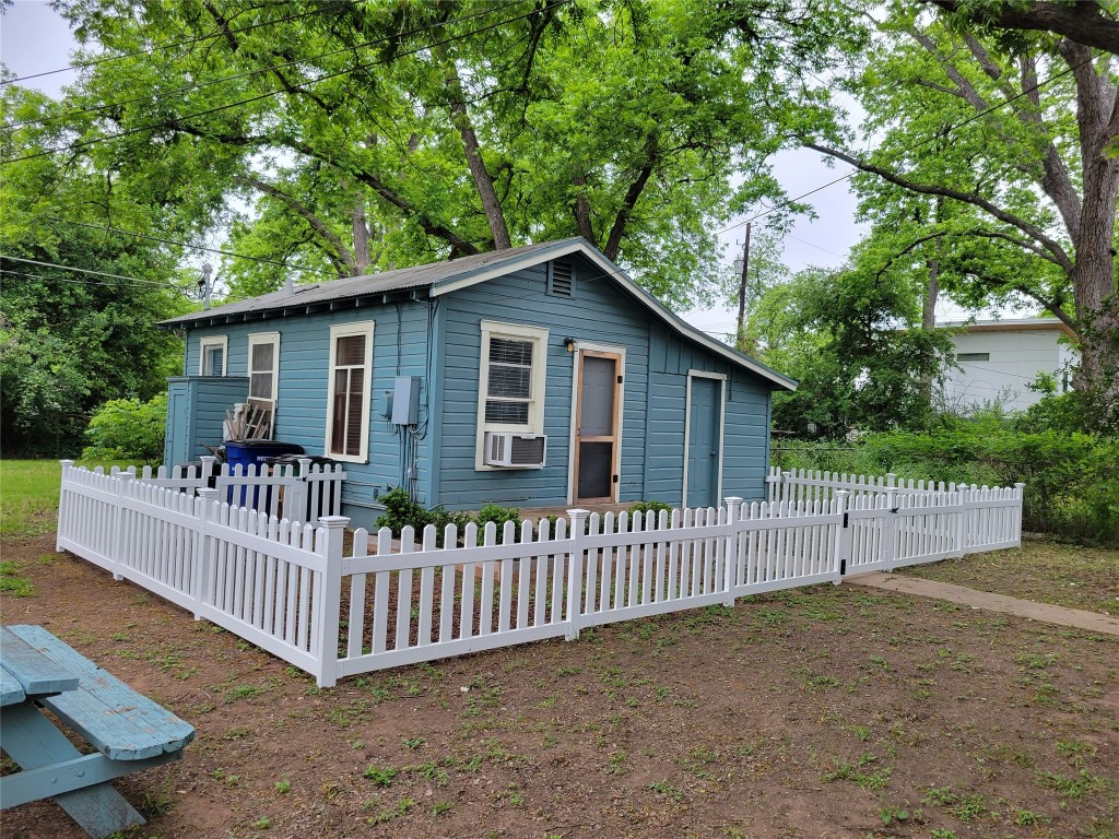 2511 East 2nd Street, Unit B Austin, TX 78702 - Photo 6 of 11 a view of a wooden house with a small yard