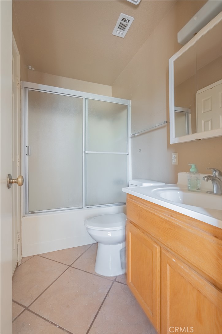 6084 Vanessa Street Riverside, CA 92504 - Photo 11 of 35 a bathroom with a granite countertop sink a toilet and bathtub