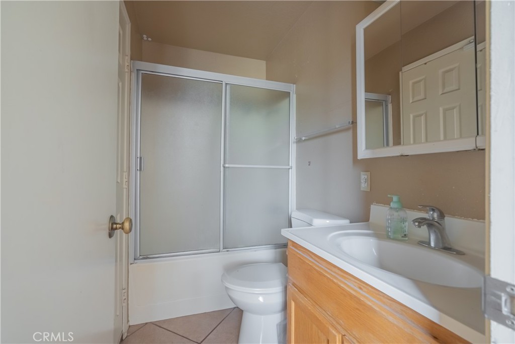 6084 Vanessa Street Riverside, CA 92504 - Photo 12 of 35 a bathroom with a granite countertop sink toilet and shower