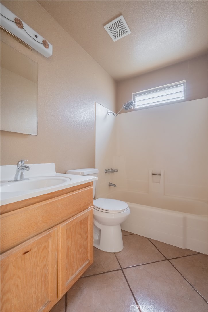 6084 Vanessa Street Riverside, CA 92504 - Photo 18 of 35 a bathroom with a toilet sink and mirror